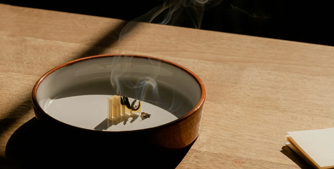 Smoking bowl on a wooden table in raking light