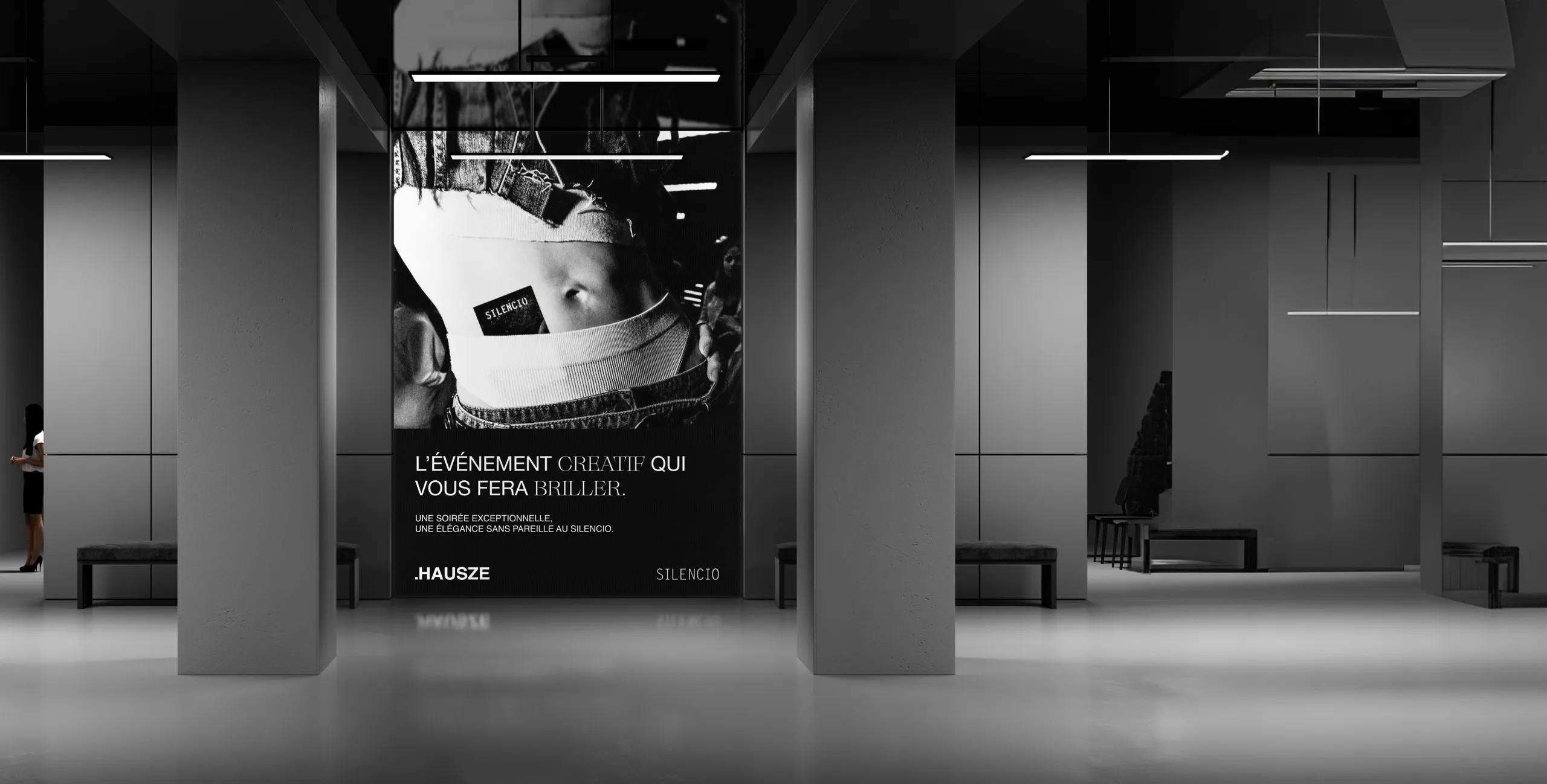 HAUSZE × SILENCIO poster on a large screen in a concrete hall